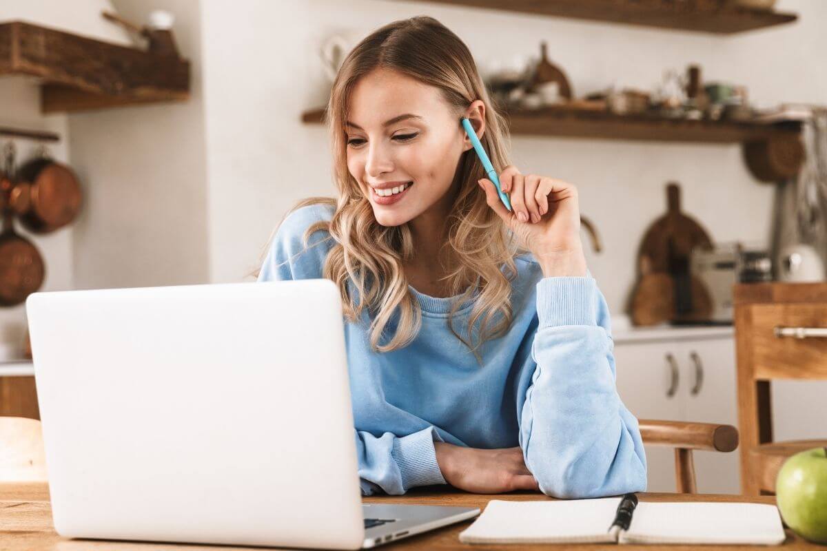 A picture of a woman using a laptop.
