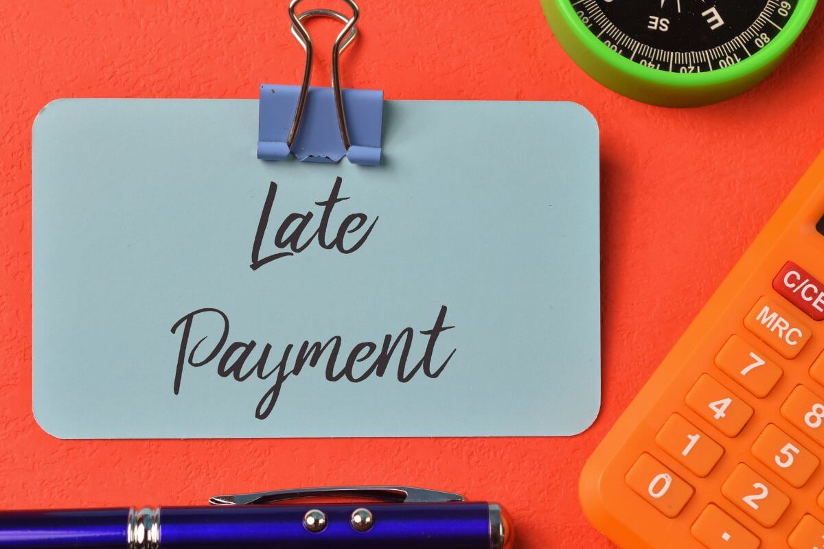 A picture shows a paper with late payment wording.