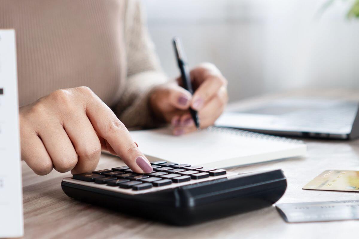 Une image d'une femme calculant ses dépenses.