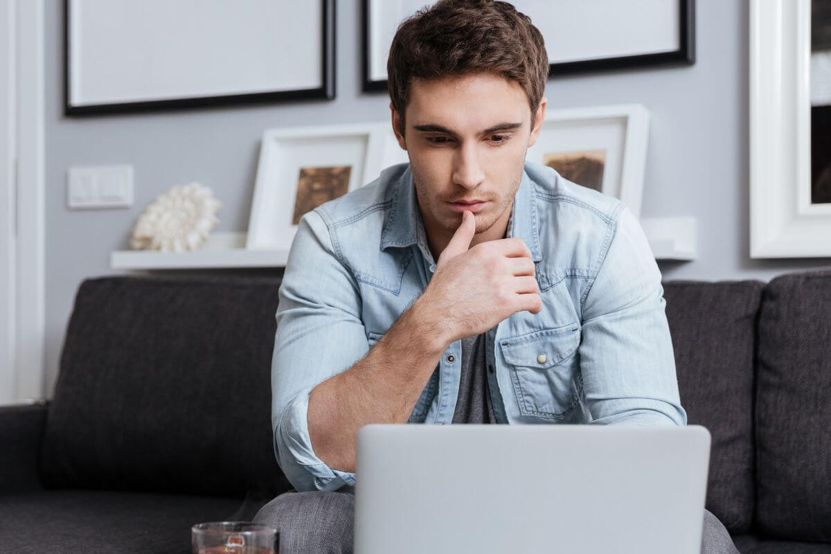 An image of a man working on a laptop.