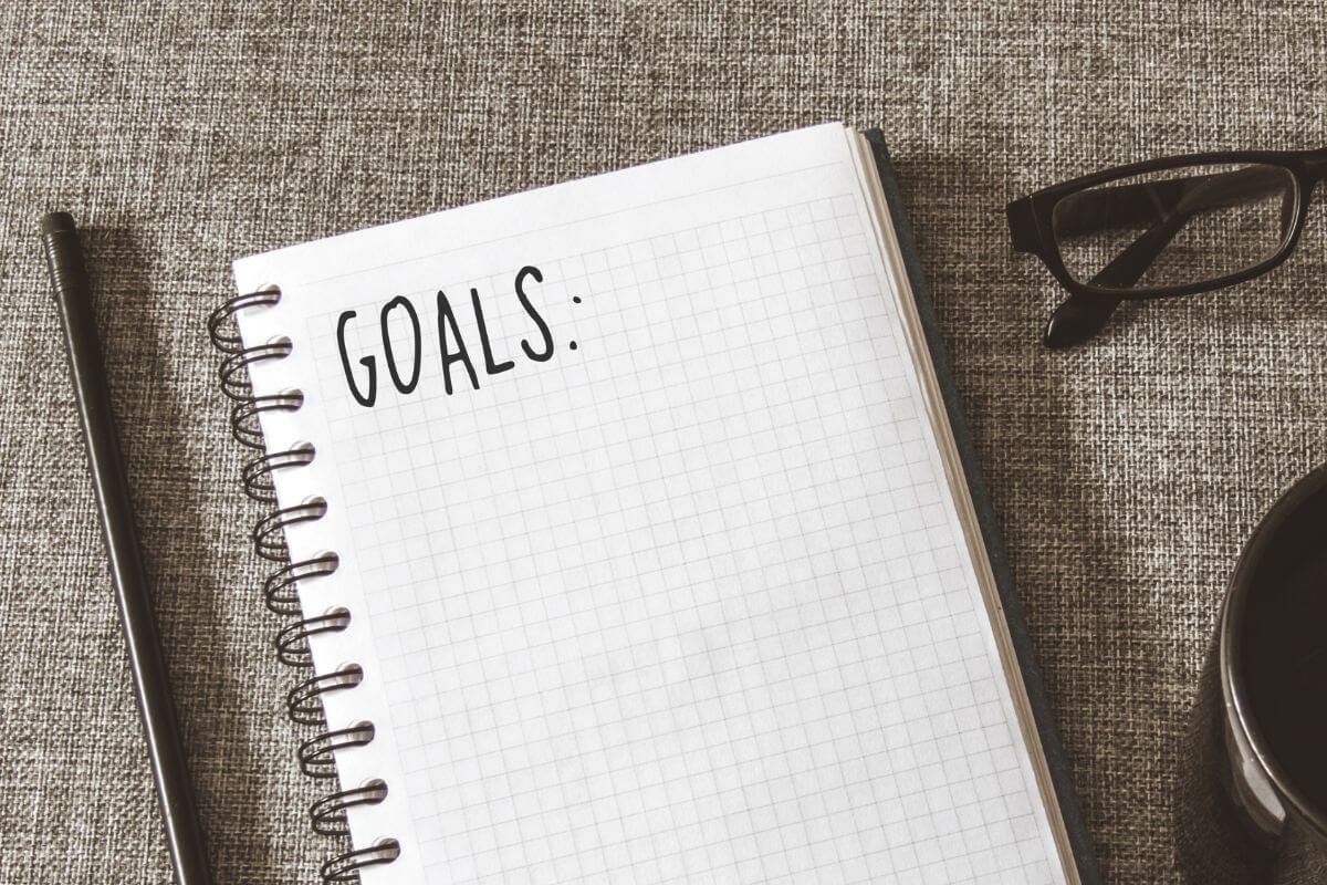 A picture shows a notebook with goals written on it.