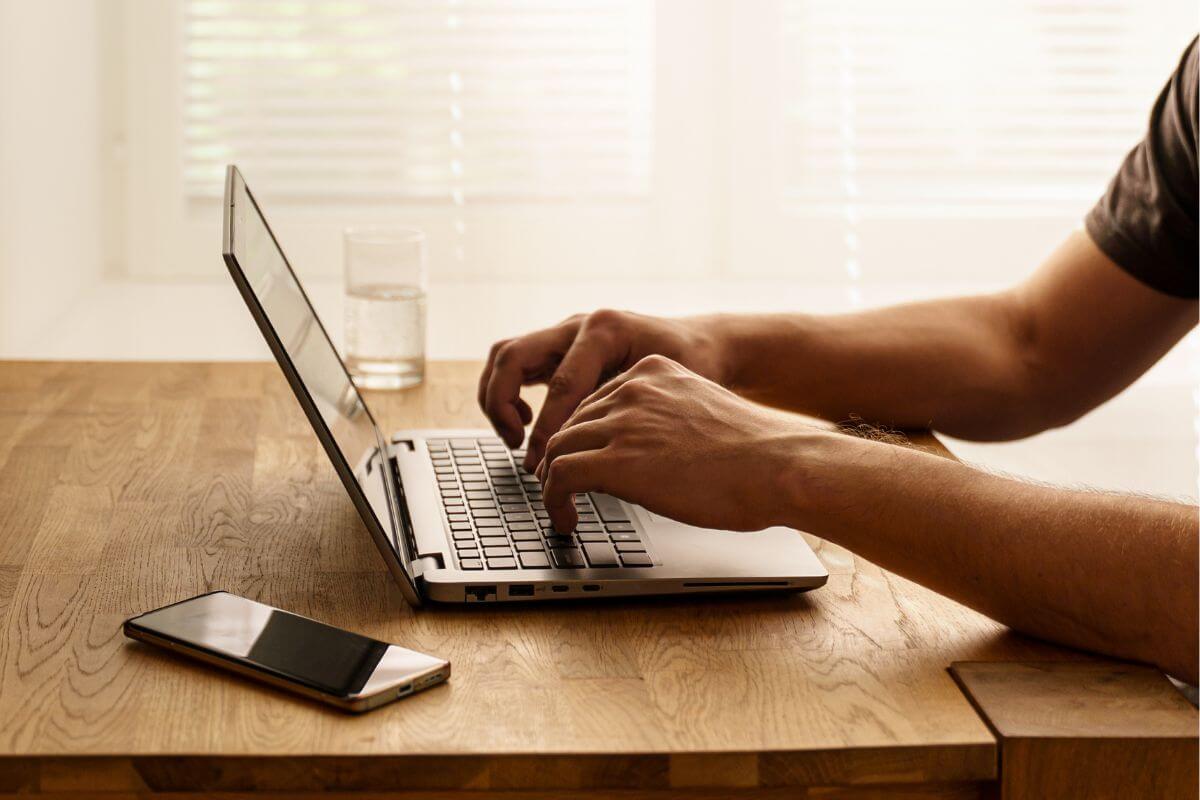 A photo shows a man using a laptop.