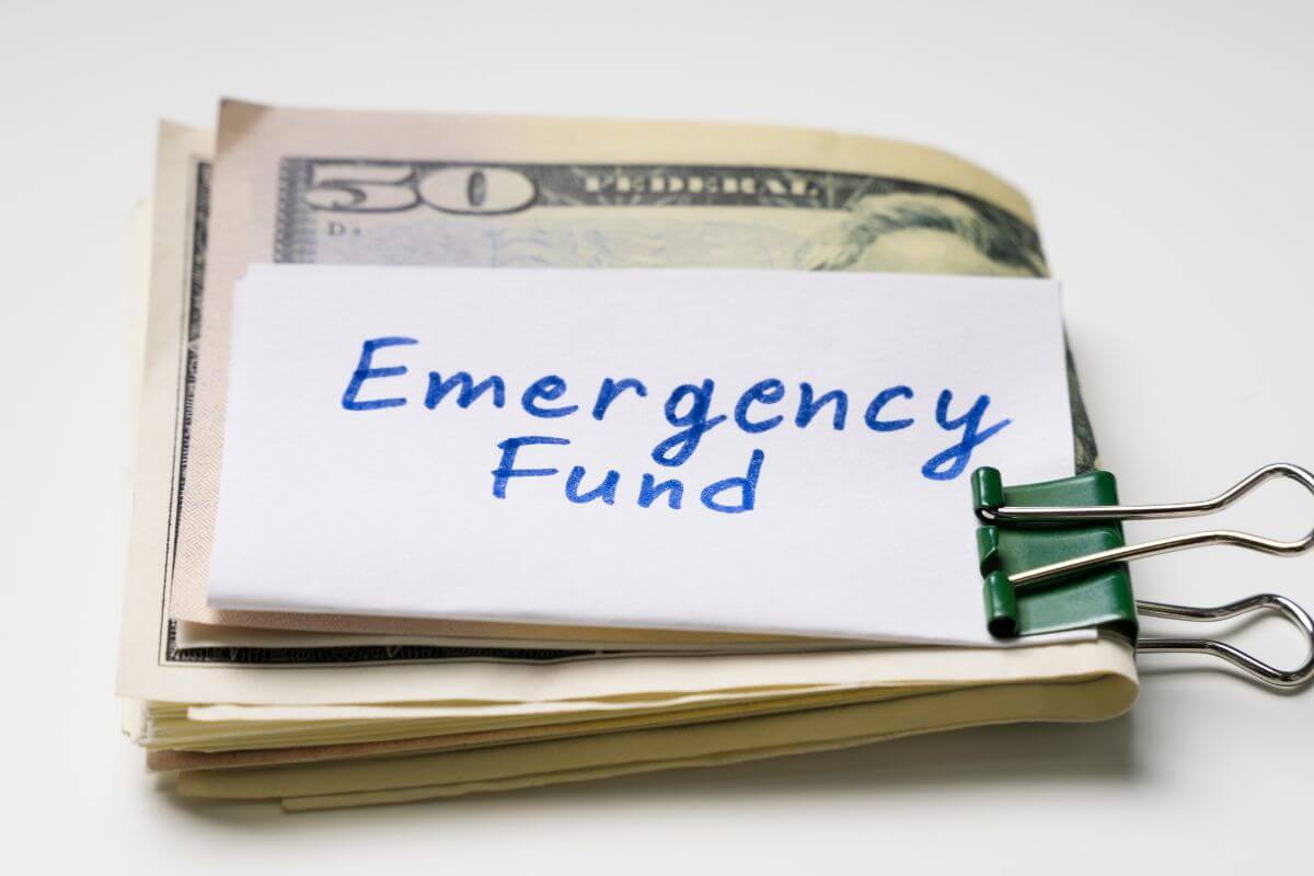 A picture of money with an emergency fund note.