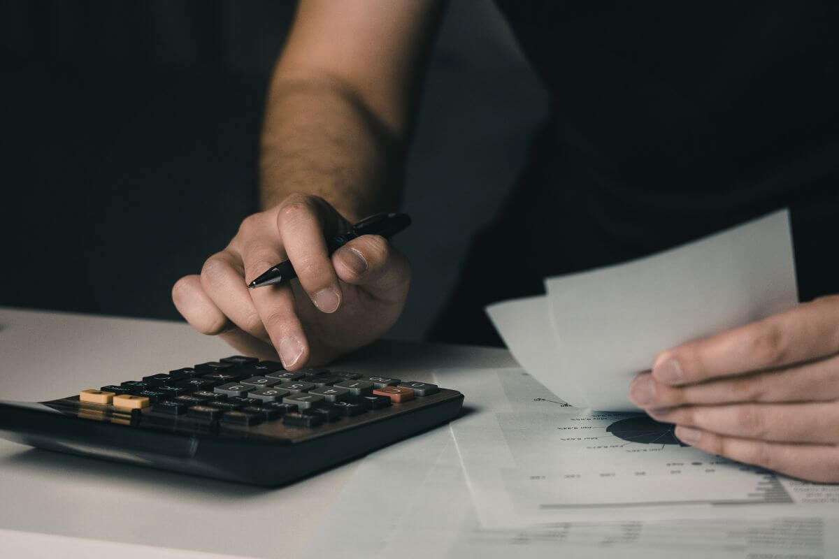 A photo shows a man calculating something.