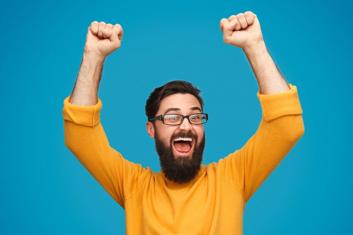 An image of a happy man cheering.