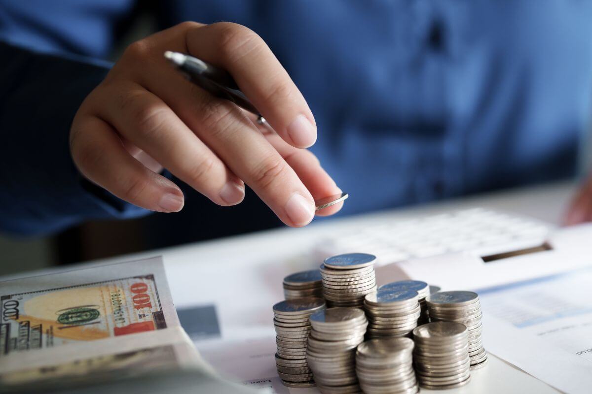 A picture of a man budgeting his money.