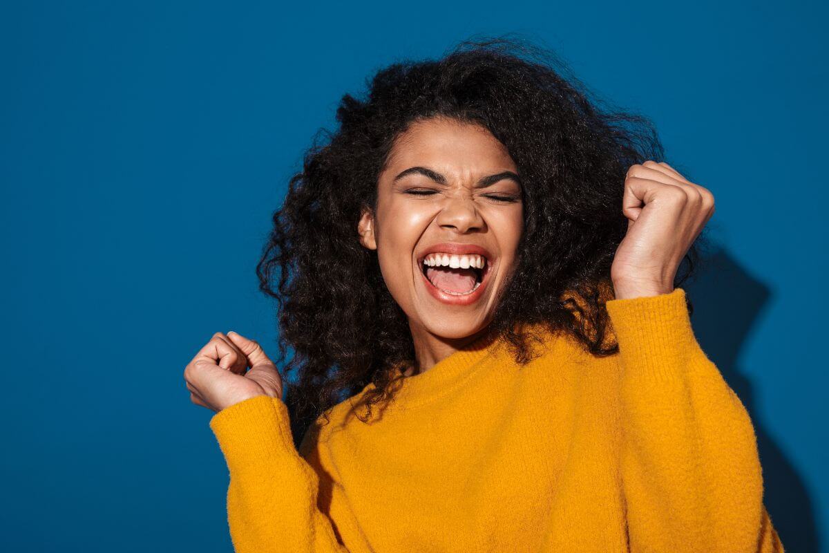 A picture of a woman cheering in excitement.