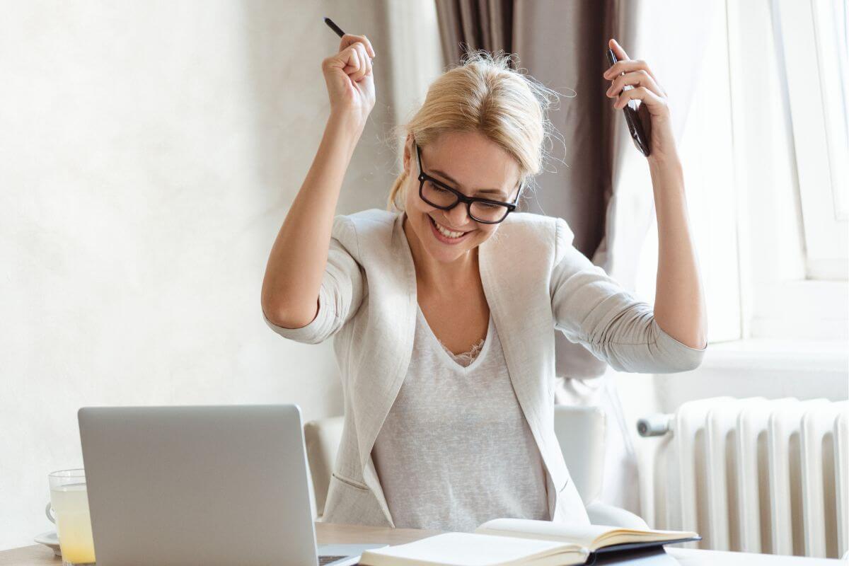 A picture of a happy woman cheering.