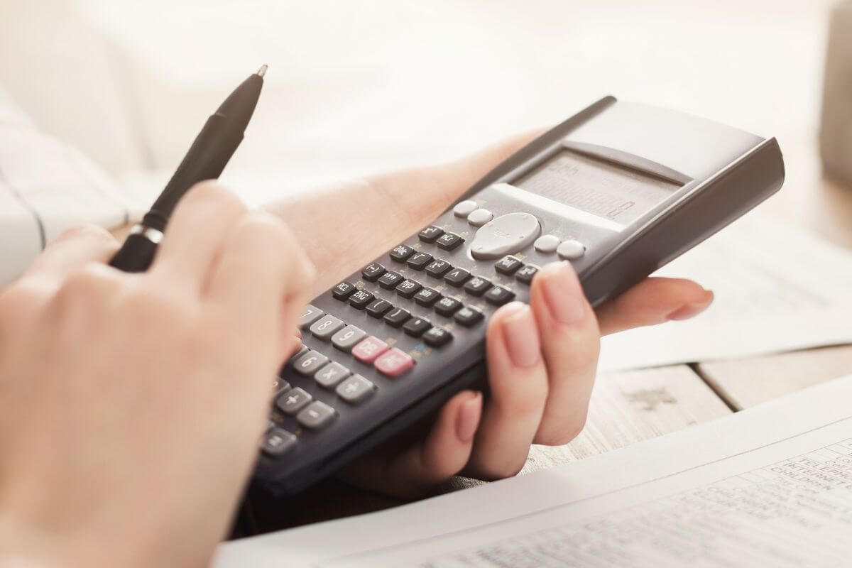 A picture of a woman's hand calculating something.
