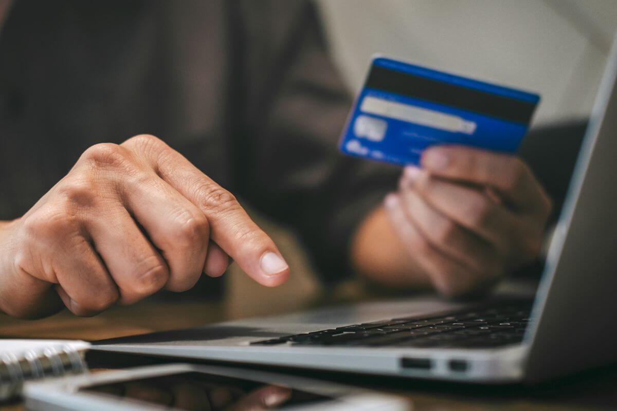 An image shows a man paying online.