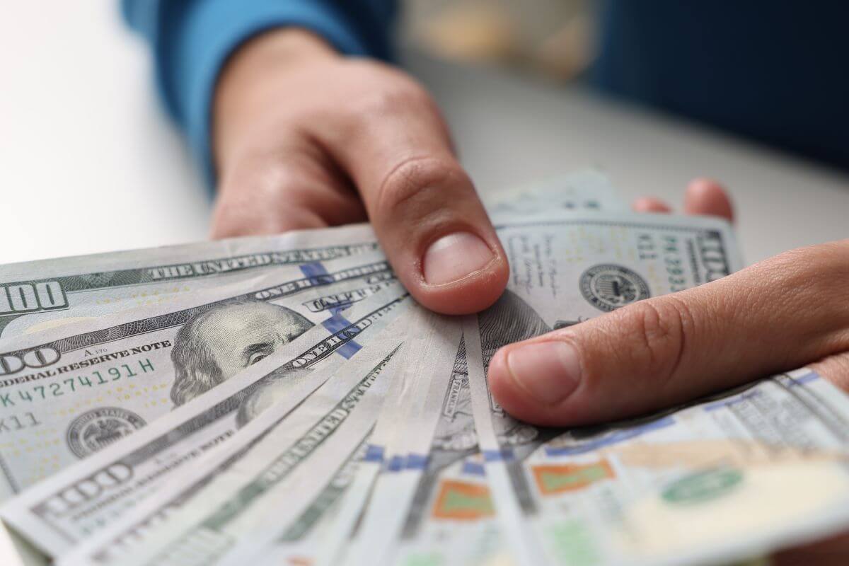 A picture of a man's hand holding money.