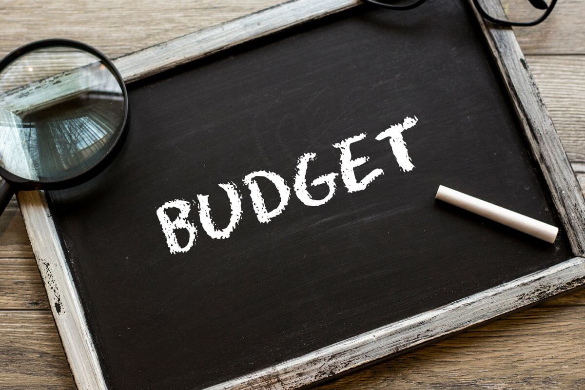 An image shows a board with budget wording.