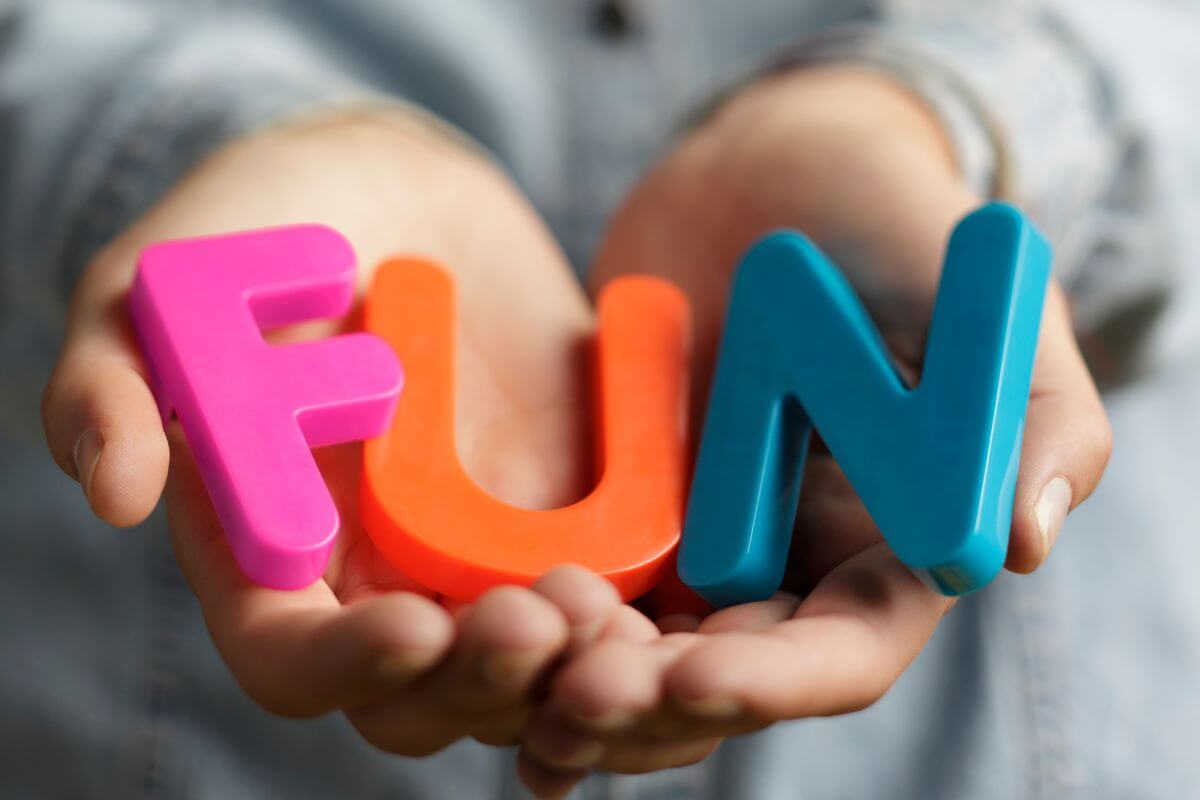 A picture of a woman's hand holding a Fun wording.