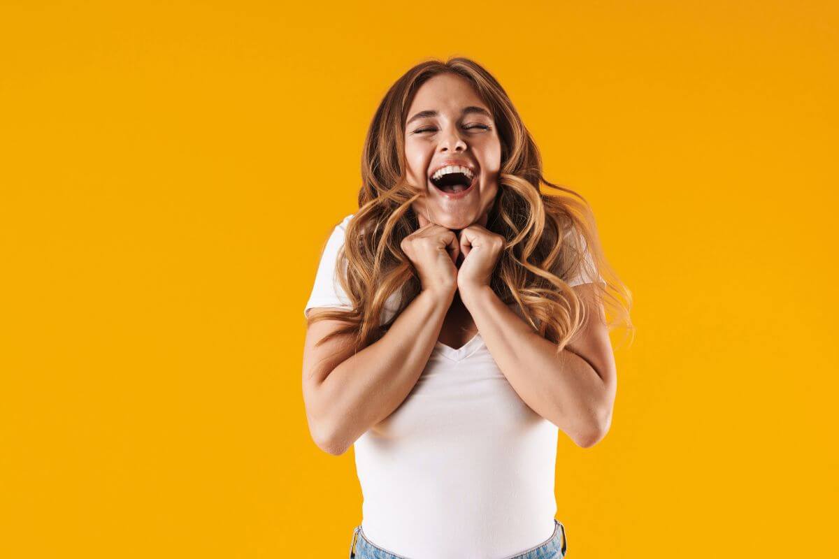A picture of a happy woman cheering.