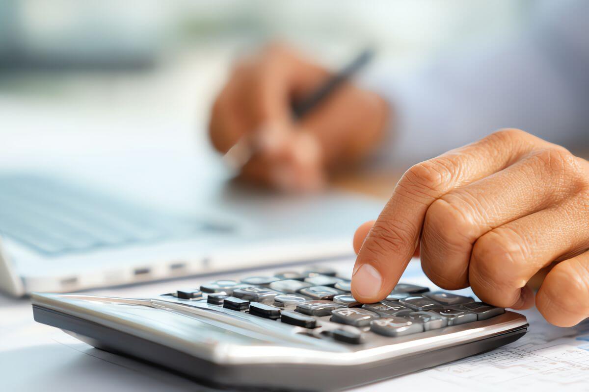 A picture shows a man's hand calculating.