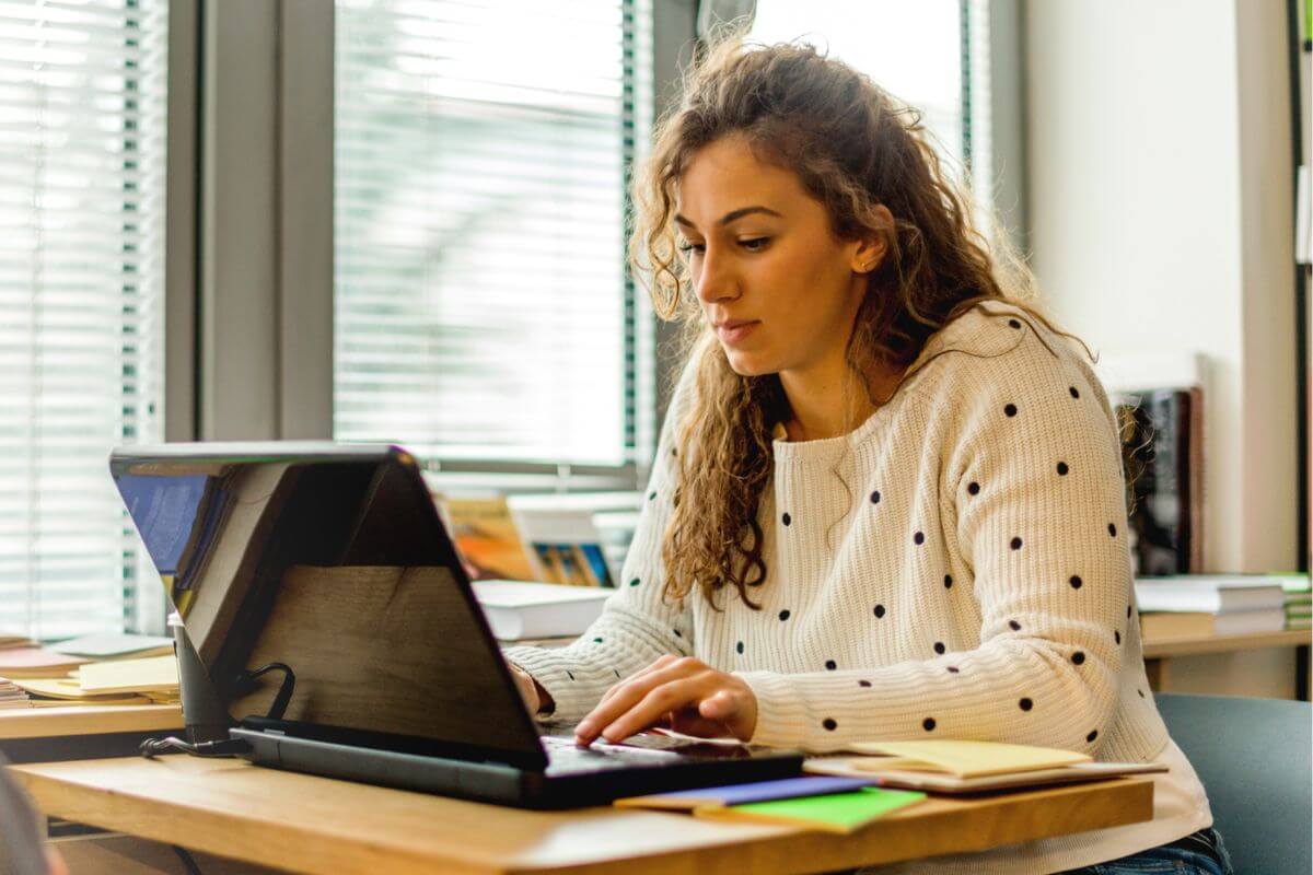 A picture of a woman using a laptop.