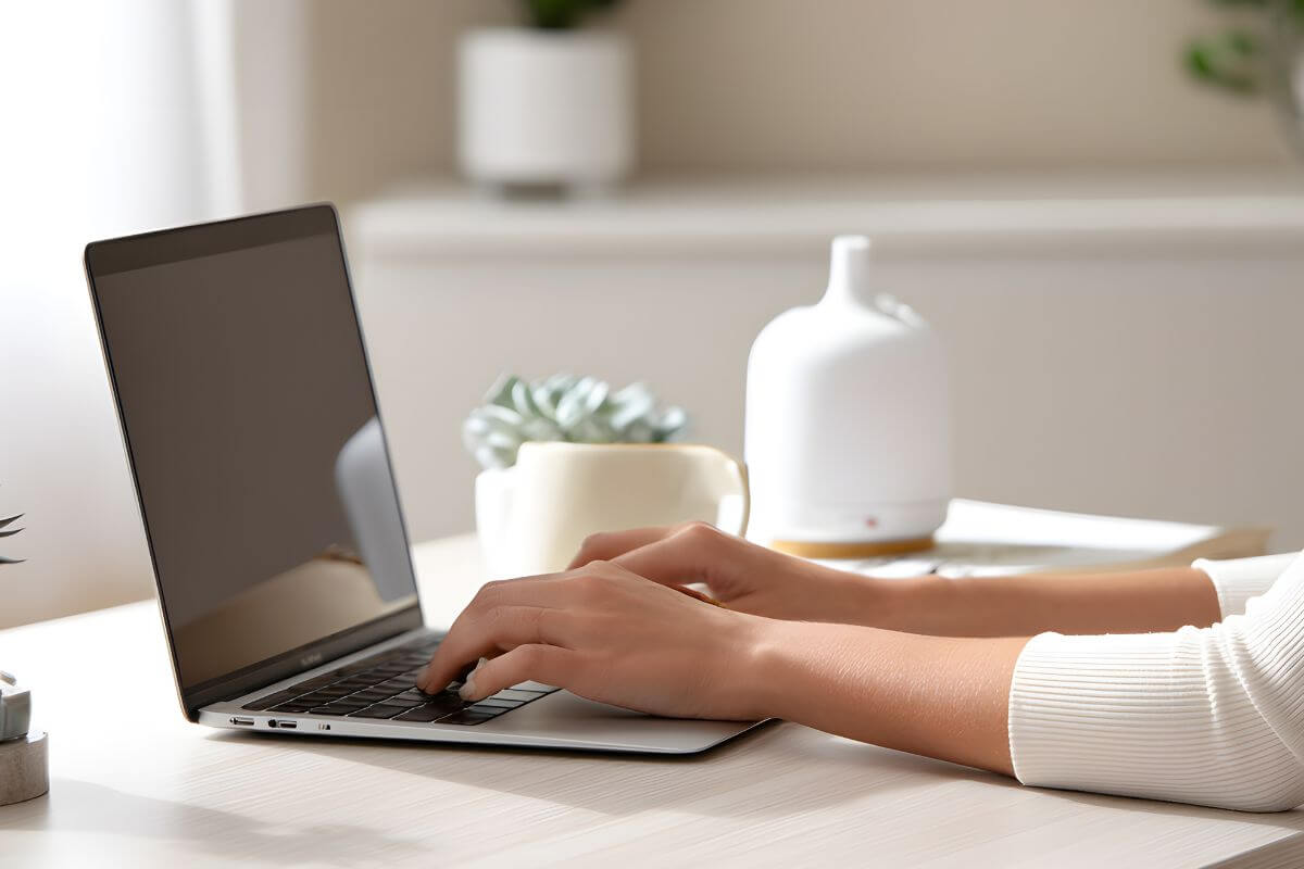 A picture shows a woman's hand using a laptop.