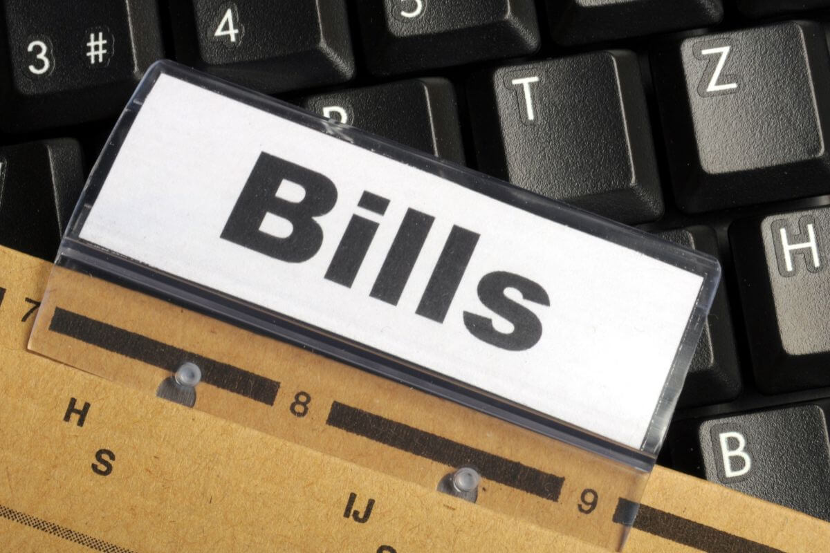 A picture of a paper with bills written on it.