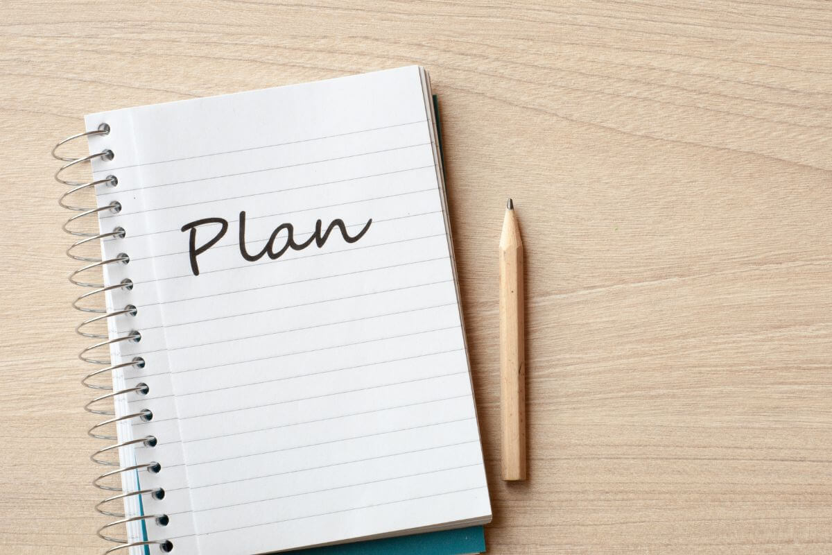 A picture shows a notebook with a plan written on it.