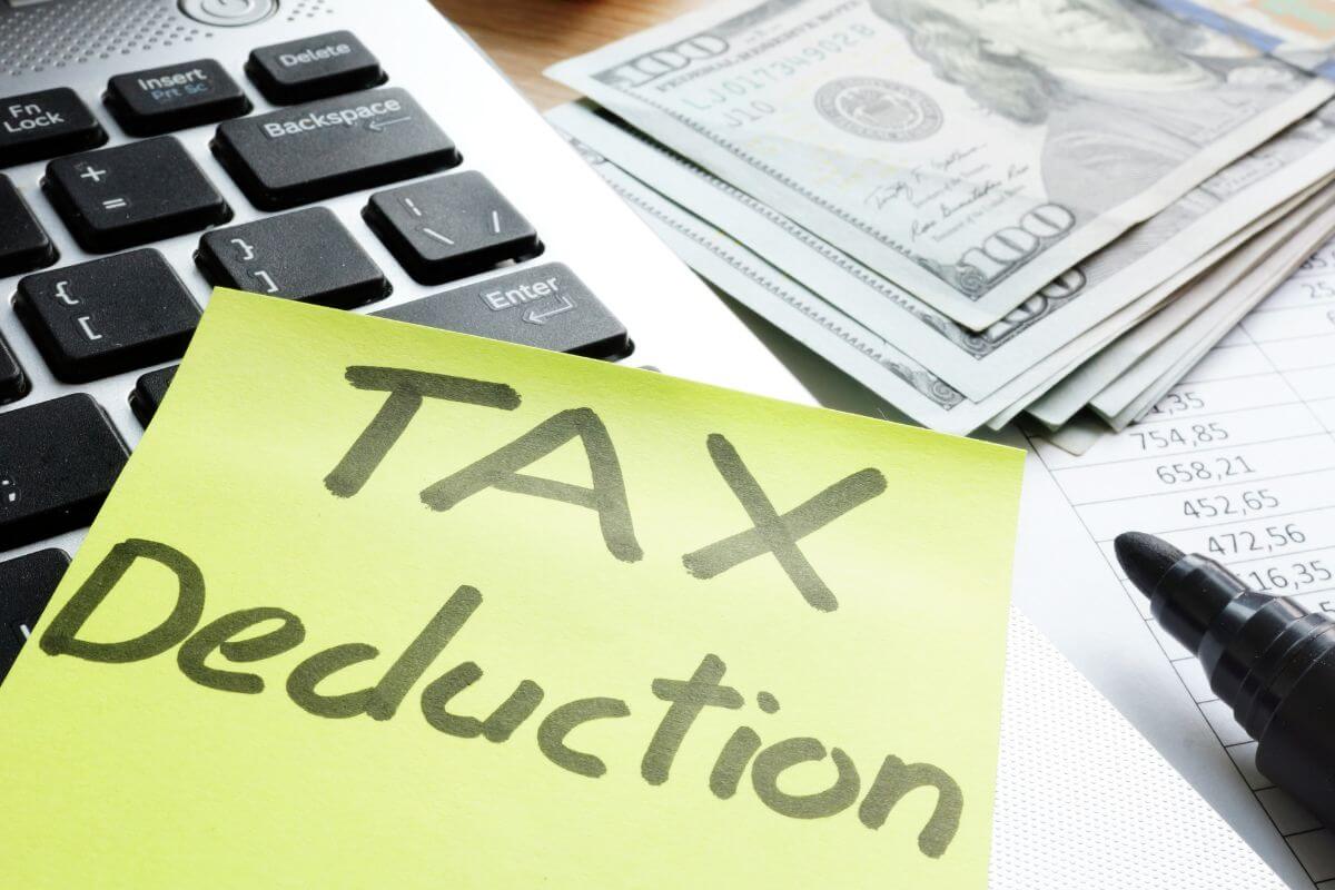 A picture shows money and tax deduction wording.