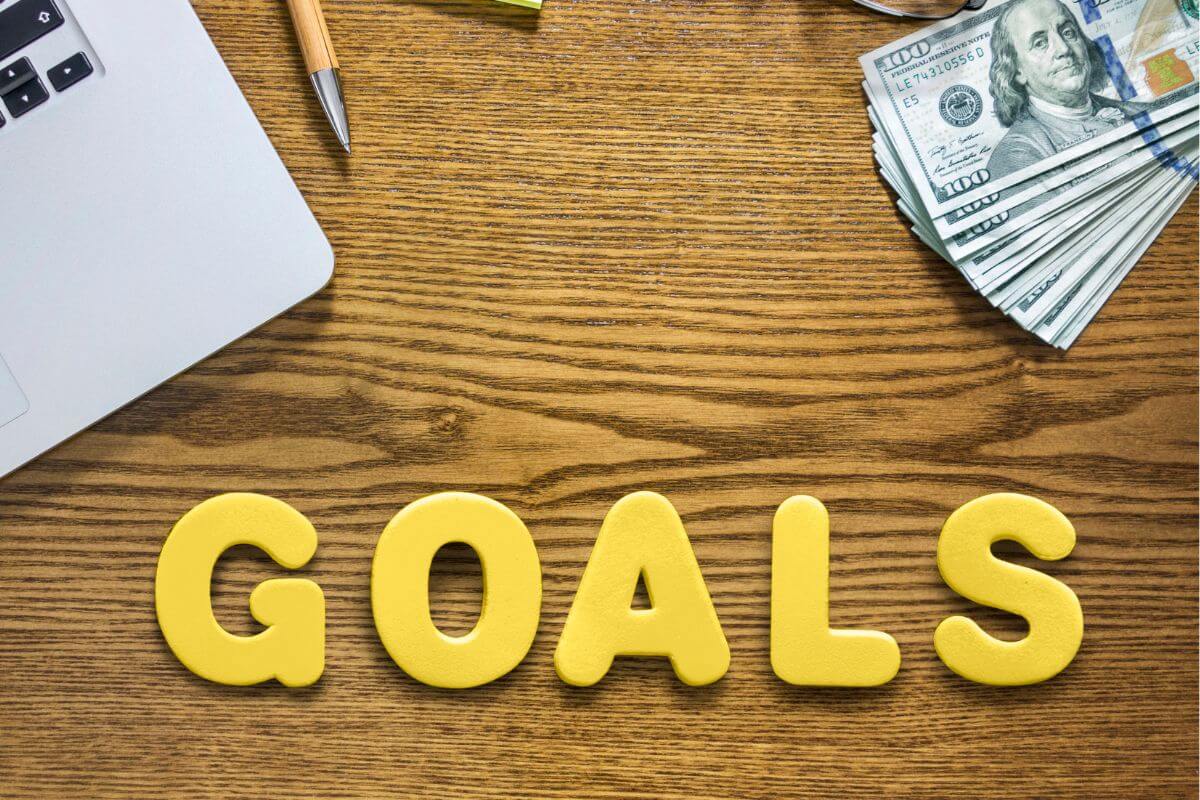 A picture shows money and goals wording.