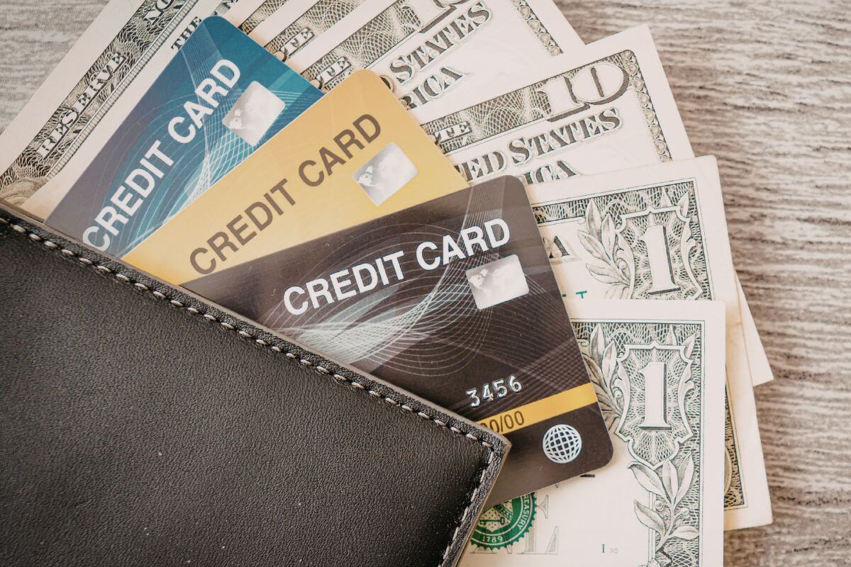 A picture of a wallet with credit cards and money.