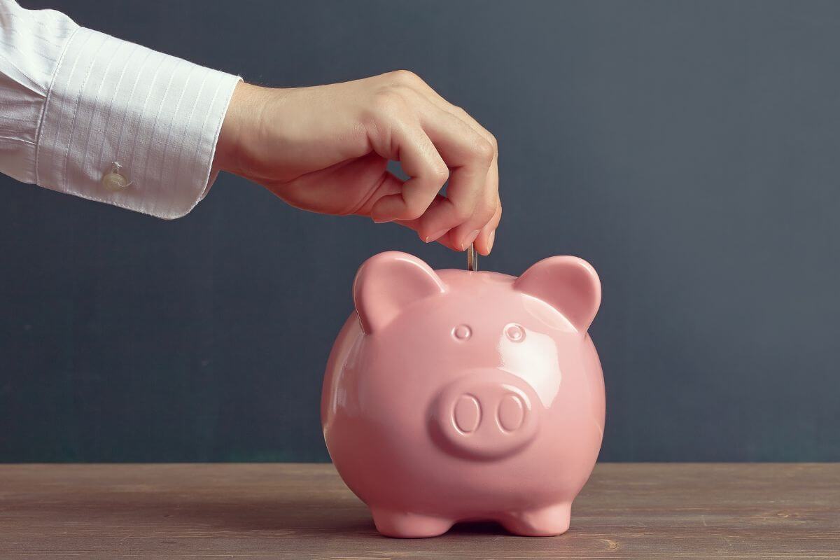 An image of a man's hand saving money.