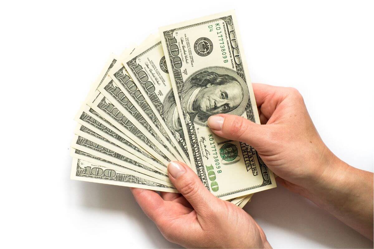 A picture of a woman's hand holding money.