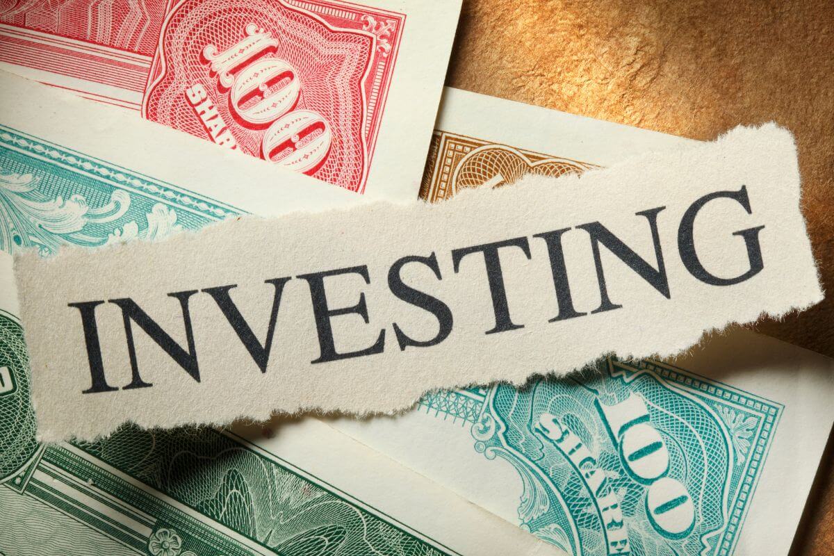 An image shows a paper with an investing word written on it.
