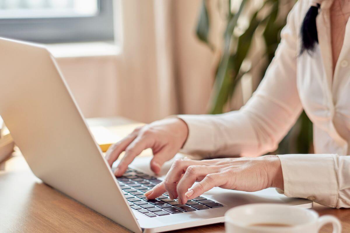 A picture of a woman using a laptop.