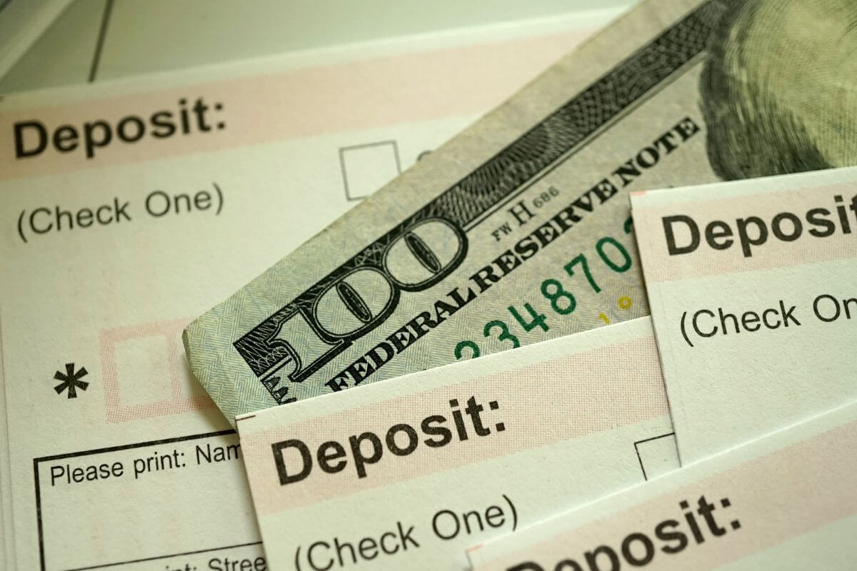 An image of deposit slips and money.