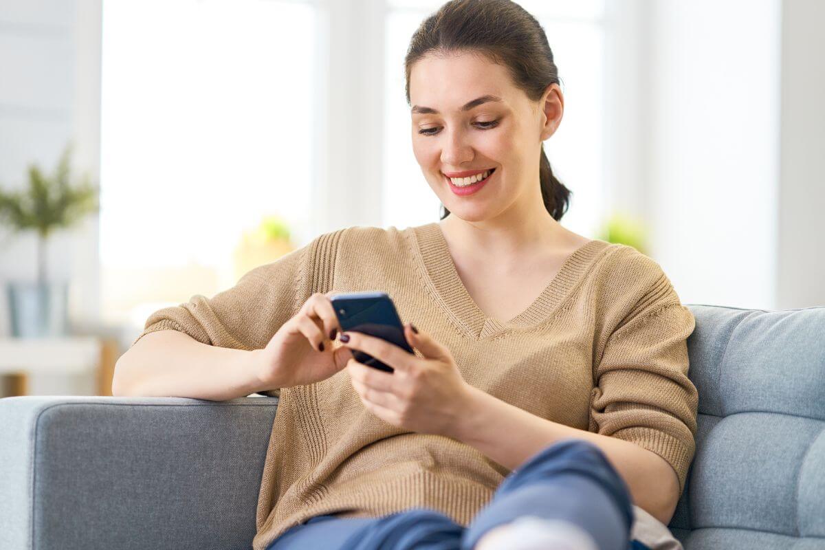A picture shows a woman using a phone.
