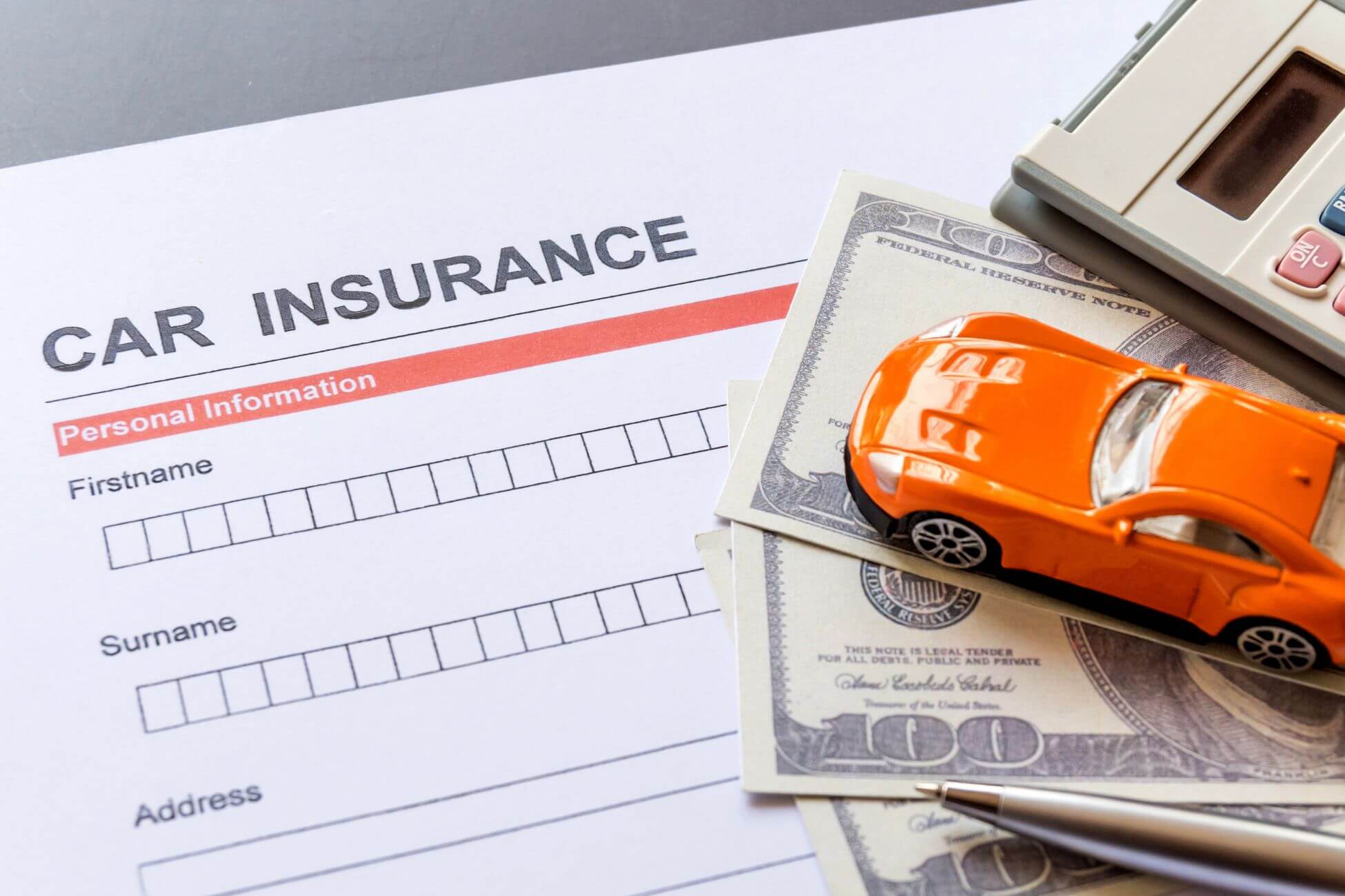 A picture of a car insurance form and money.