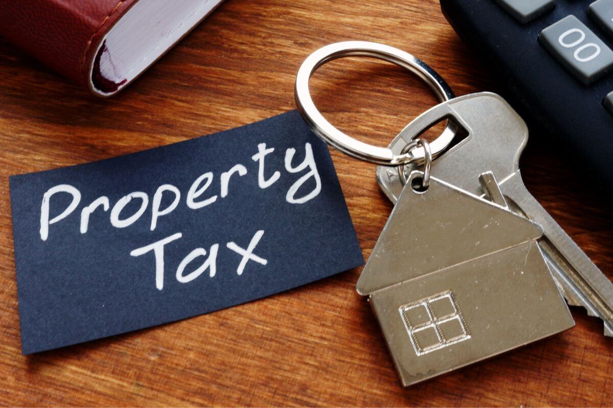 A picture of a paper with property tax written on it and a key.