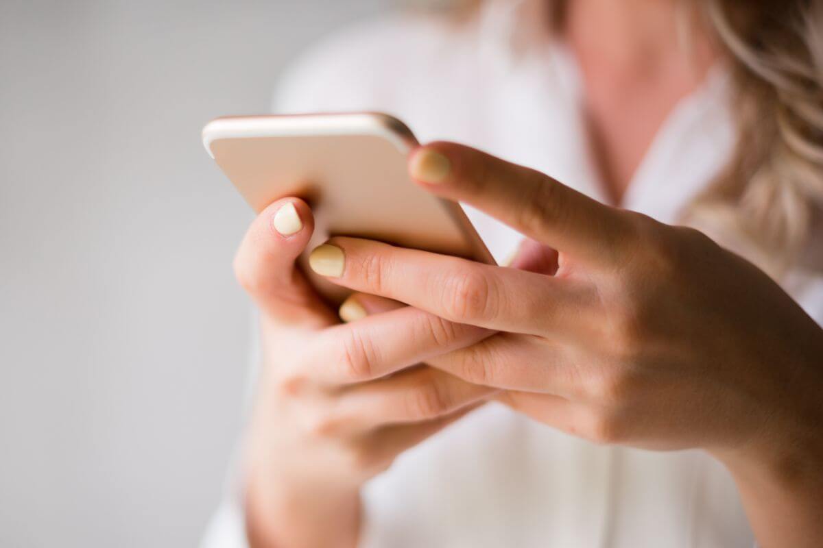 A picture of a woman using a phone.