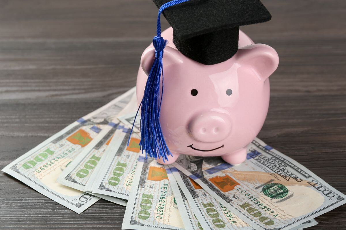 A picture of money, a piggy bank, and a graduation hat.