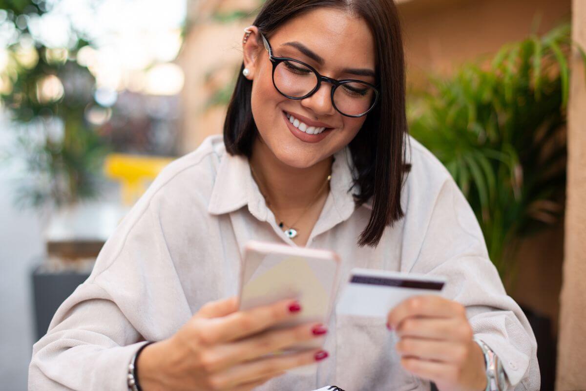 An image shows a woman making a payment online. 