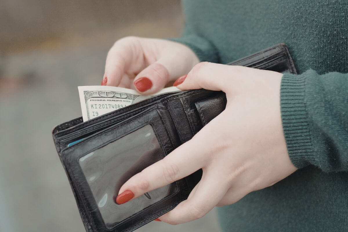 One photo shows a woman holding her wallet filled with money.