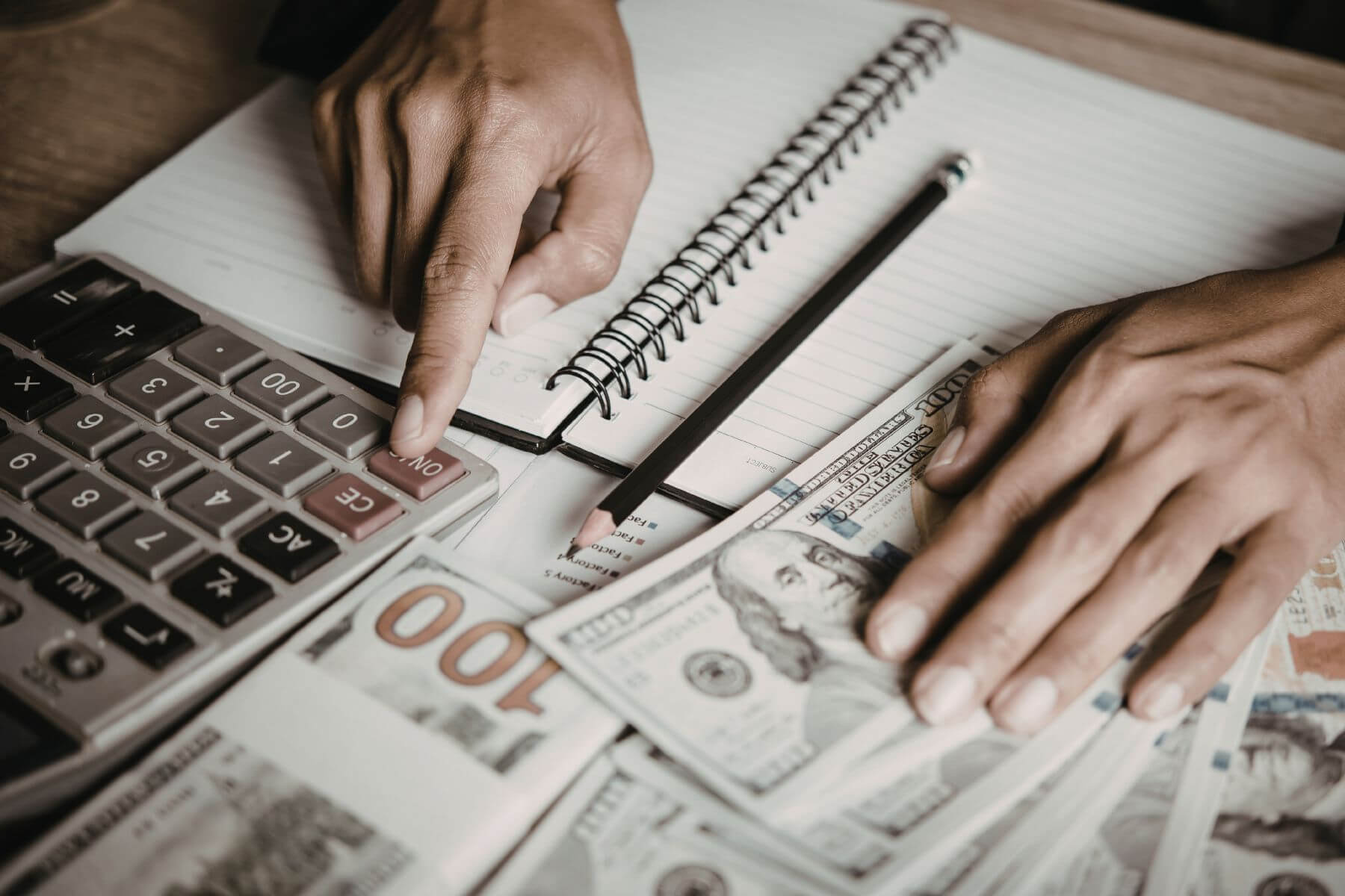 A picture of a man calculating money.