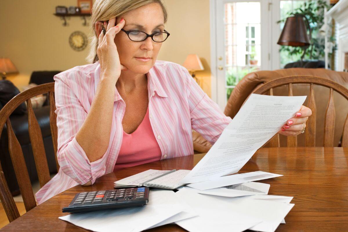An image of a woman reviewing her bills.