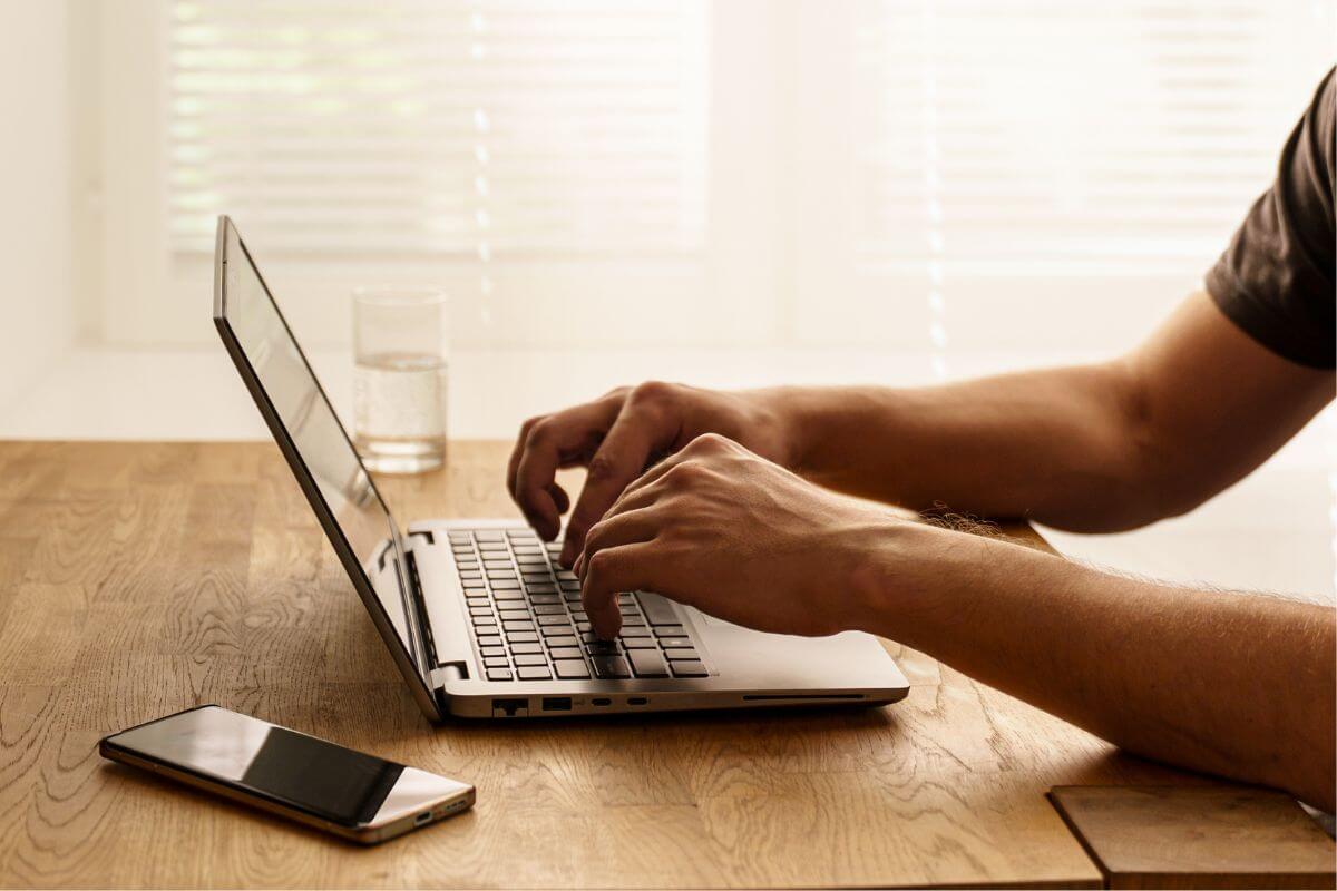 An image shows a man using a laptop.