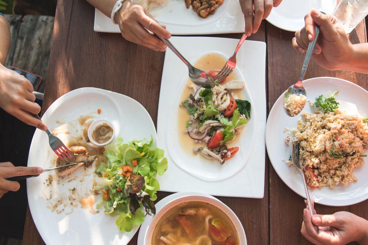 A picture shows a group of people eating out.