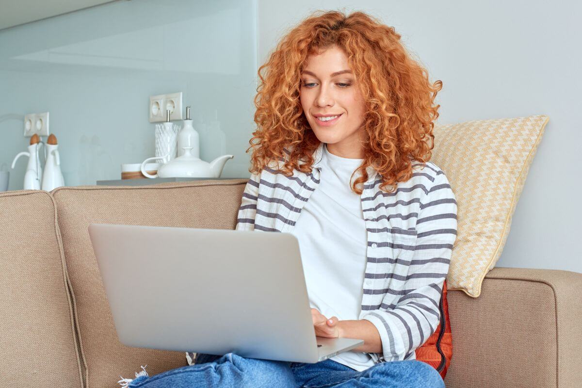 A picture of a woman using a laptop.