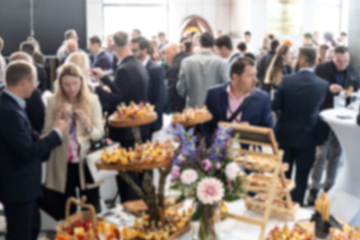 An image shows a group of people at the event.