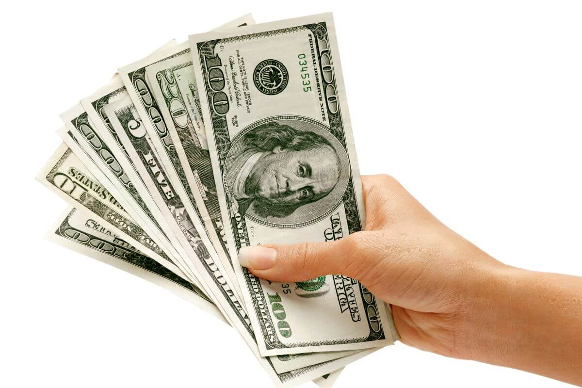 A picture of a woman's hand holding money.