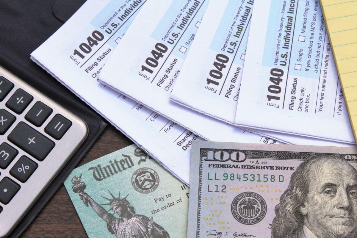 A picture shows tax documents and money.