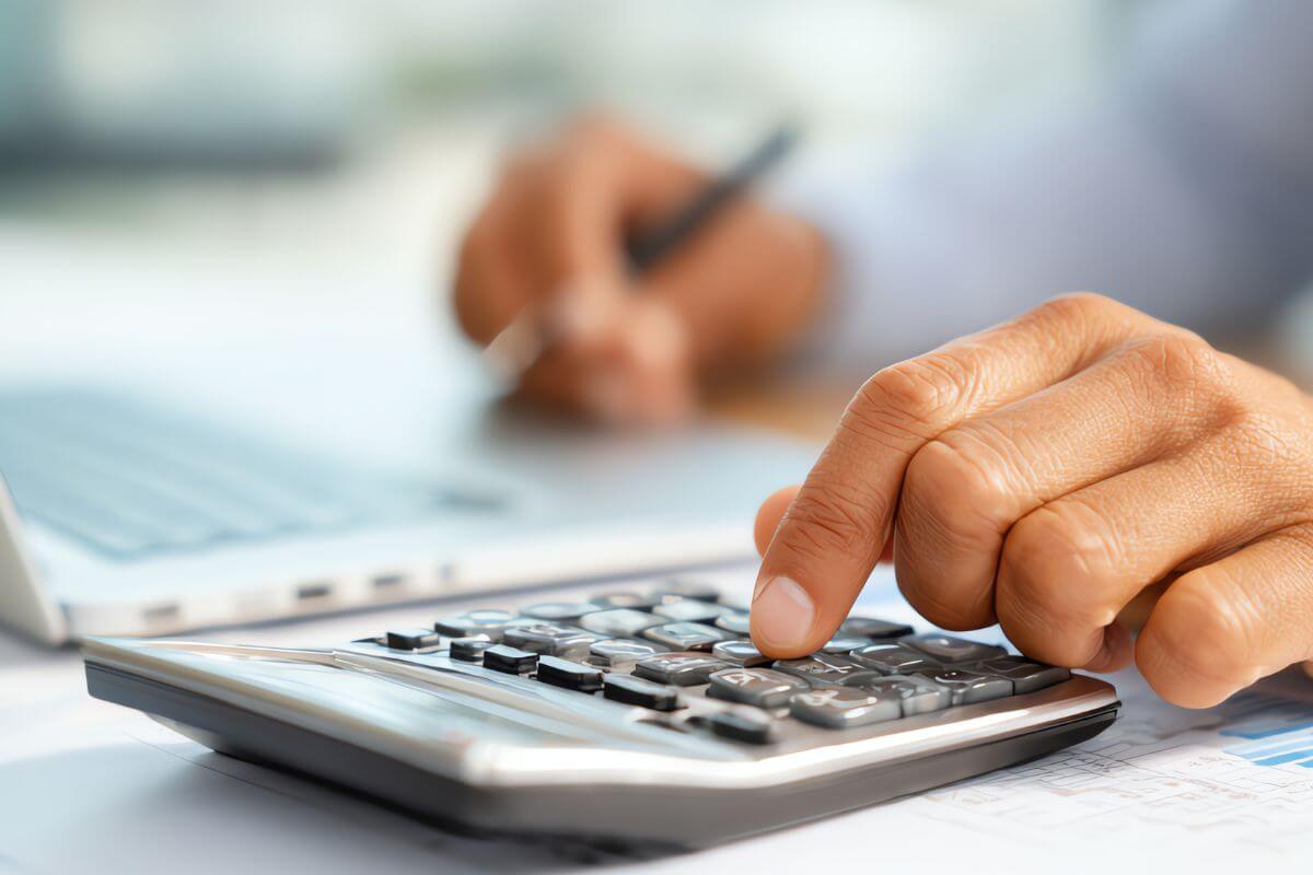An image shows a man's hand calculating something.