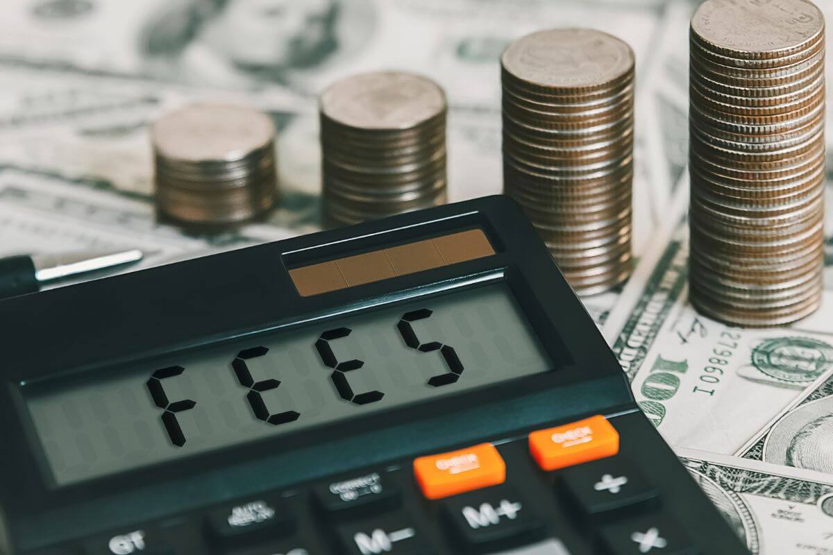 A picture shows money and a calculator with the word Fees.