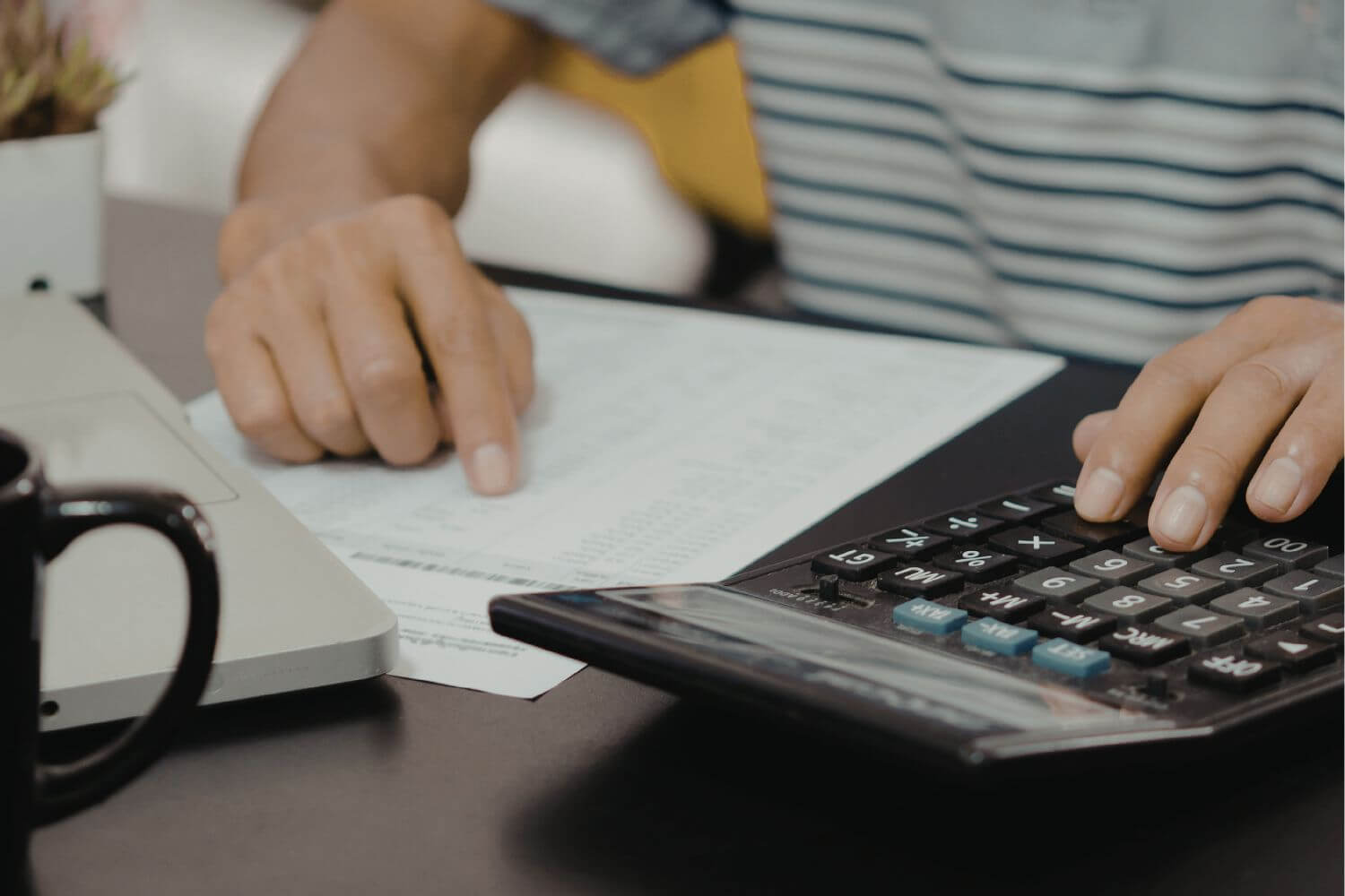 An image of a man calculating his expenses.