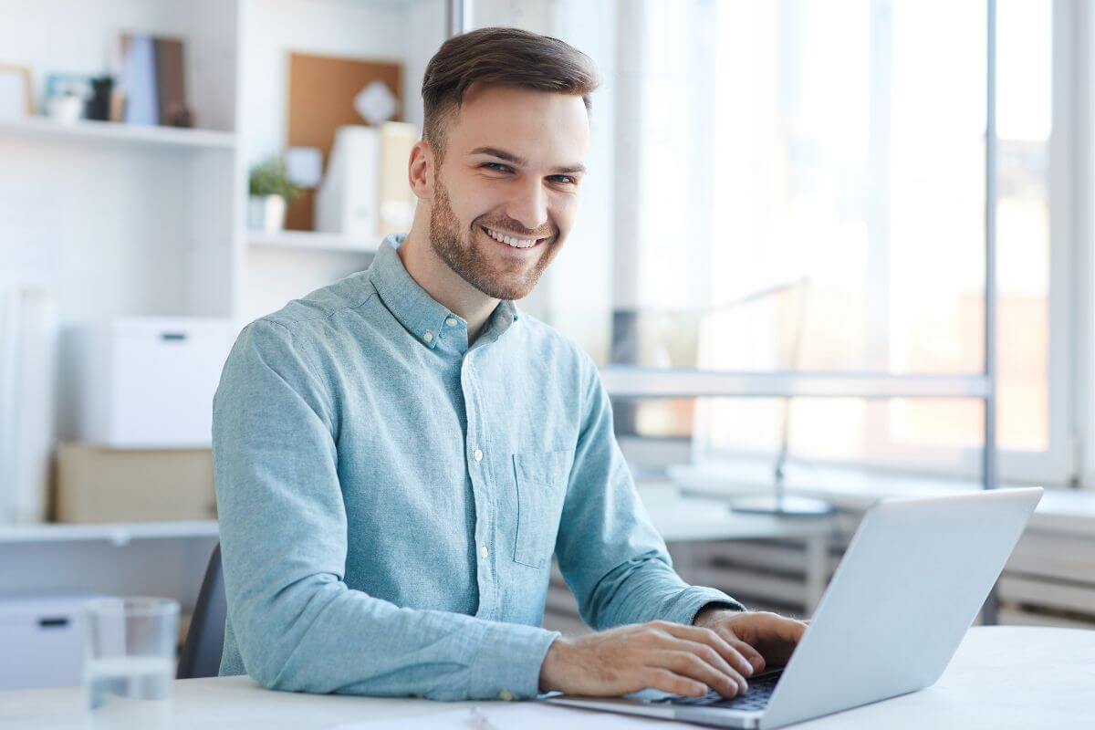 A picture shows a man using a laptop.